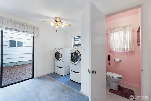 a bathroom with a toilet and a mirror