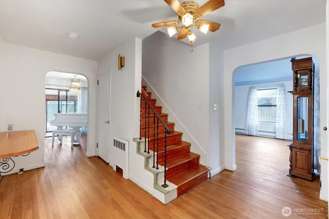 a view of entryway and hall with wooden floor