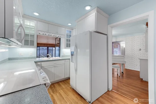 a kitchen with stainless steel appliances a refrigerator and a stove top oven