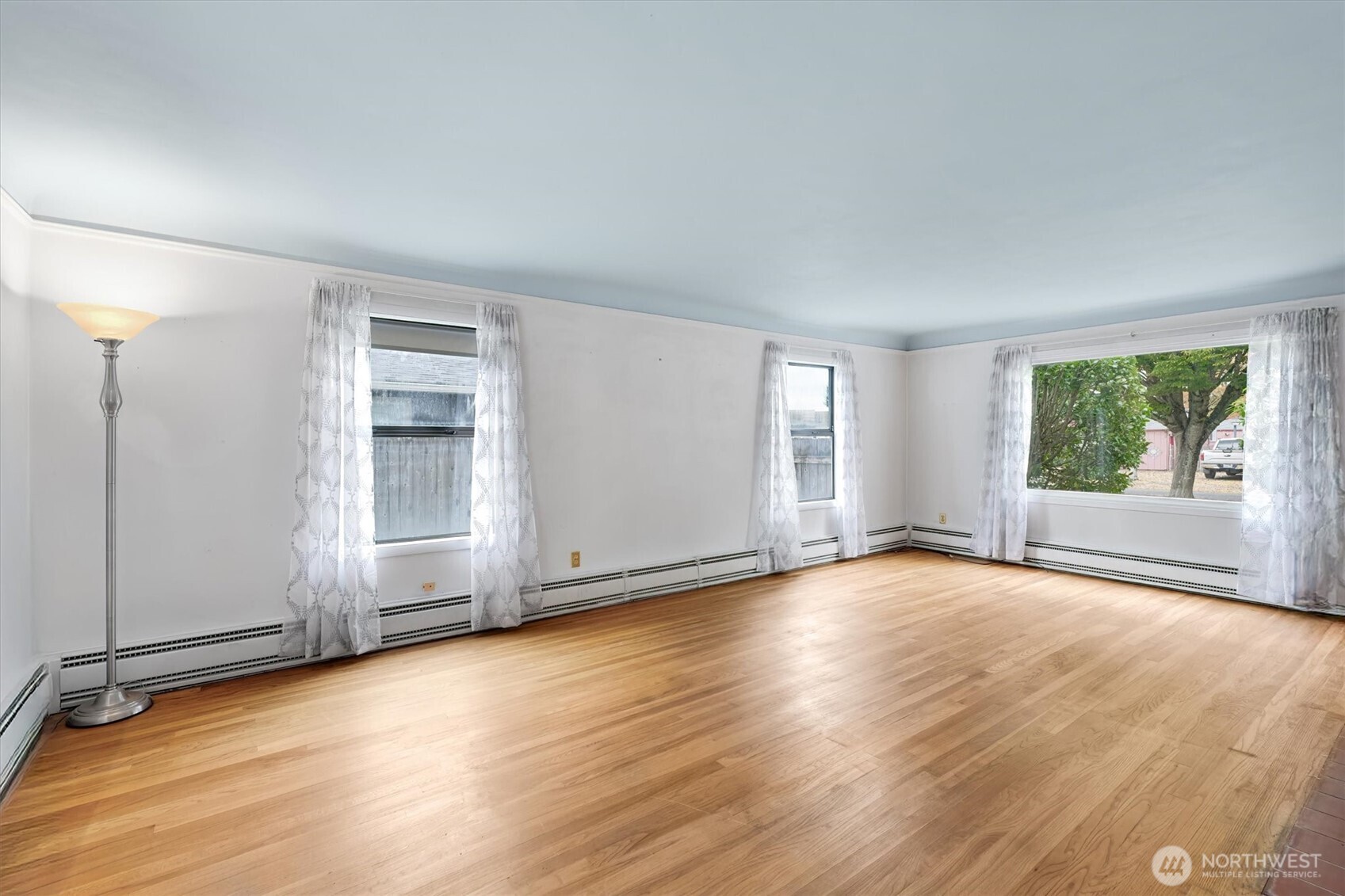 2727 Hemlock Street Longview, WA 98632 - Photo 9 of 40 an empty room with wooden floor and windows