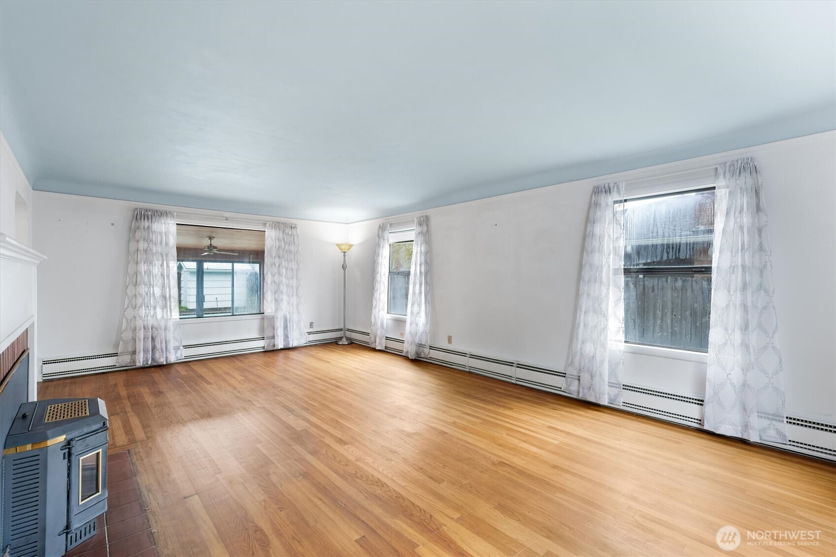 2727 Hemlock Street Longview, WA 98632 - Photo 10 of 40 an empty room with wooden floor and windows
