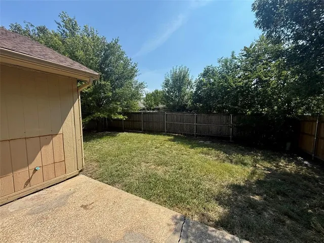 a backyard of a house with lots of green space