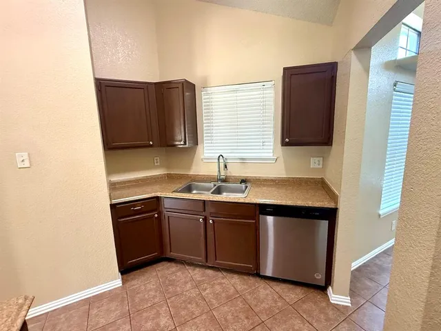 a kitchen with stainless steel appliances granite countertop a sink and a stove