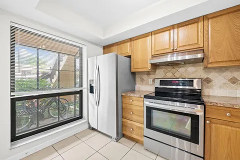 a kitchen with stainless steel appliances granite countertop a refrigerator sink and stove