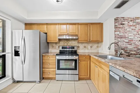 a kitchen with stainless steel appliances granite countertop a stove and a refrigerator