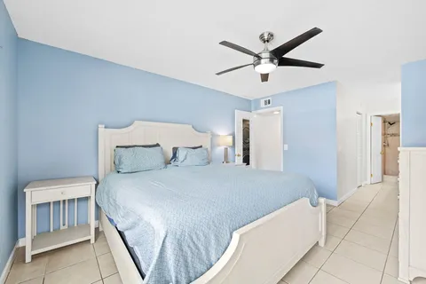 a bedroom with a large bed and a flat screen tv