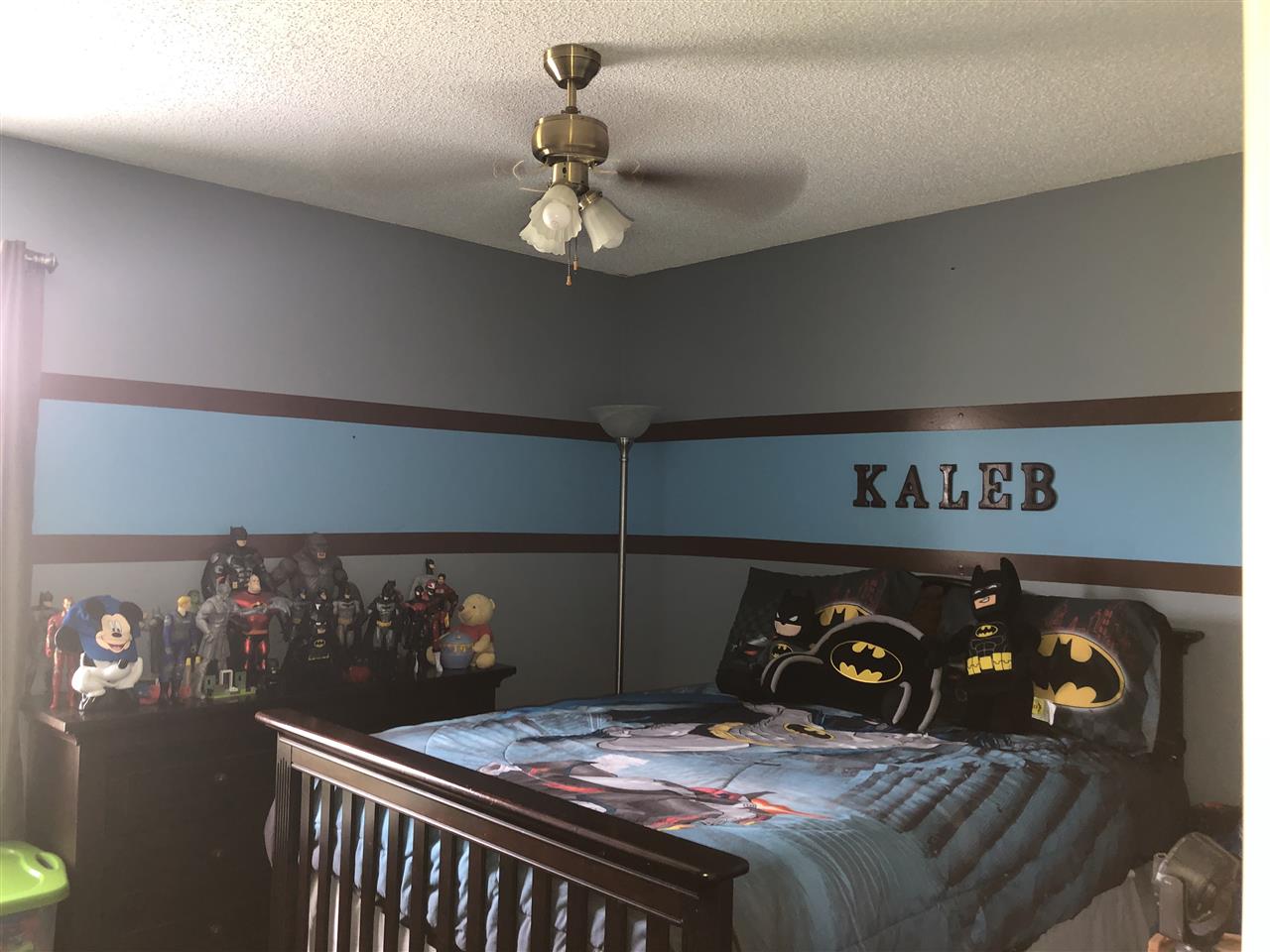 5509 Edwin Forest Road Memphis, TN 38141 - Photo 16 of 19 a bed sitting in a bedroom next to a chandelier