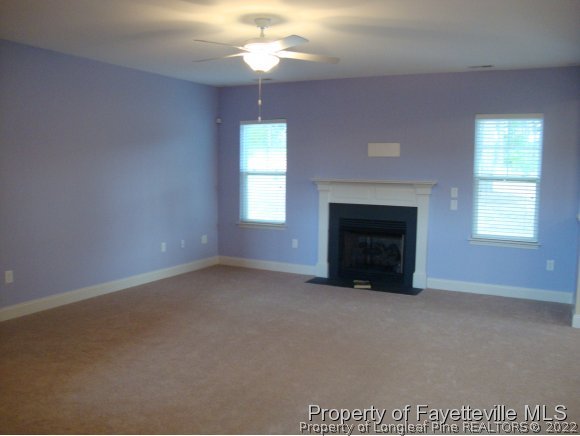717 Sun Road Aberdeen, NC 28315 - Photo 11 of 14 an empty room with windows and fireplace