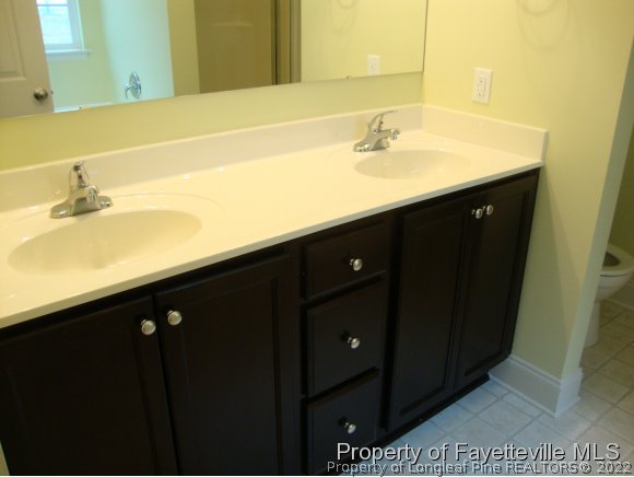 717 Sun Road Aberdeen, NC 28315 - Photo 12 of 14 a bathroom with a sink and a mirror