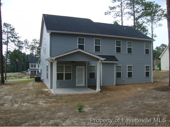 717 Sun Road Aberdeen, NC 28315 - Photo 3 of 14 a front view of a house with a yard and garage