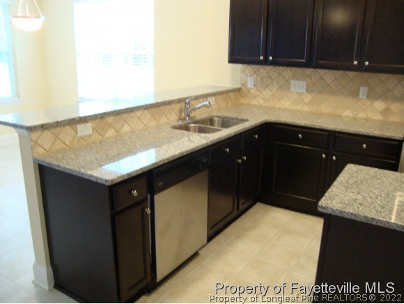 717 Sun Road Aberdeen, NC 28315 - Photo 5 of 14 a kitchen with a sink and cabinets