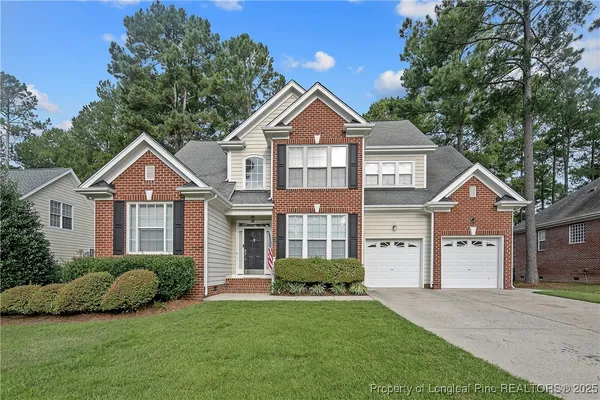 a front view of a house with a yard and garage