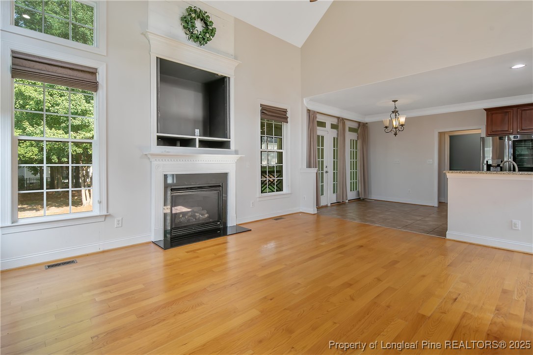 399 Falling Water Road Spring Lake, NC 28390 - Photo 11 of 50 a view of an empty room with a fireplace and a window