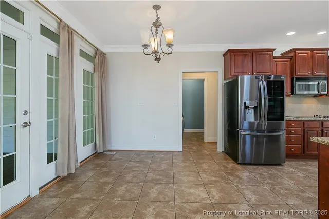 a view of a kitchen with a refrigerator and a stove top oven