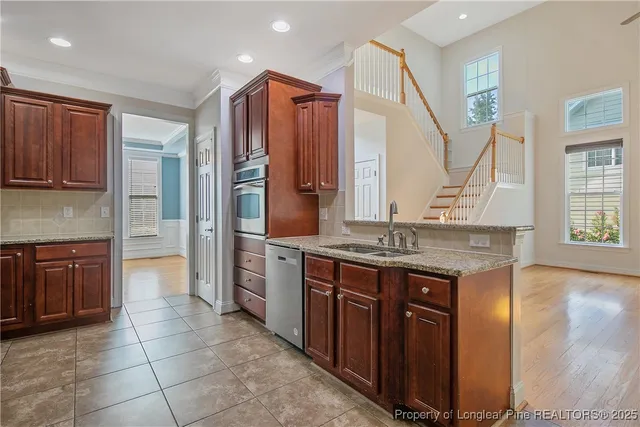 a kitchen with a sink stove and cabinets
