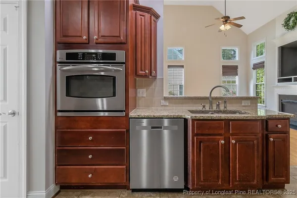 a kitchen with stainless steel appliances granite countertop a stove and a microwave