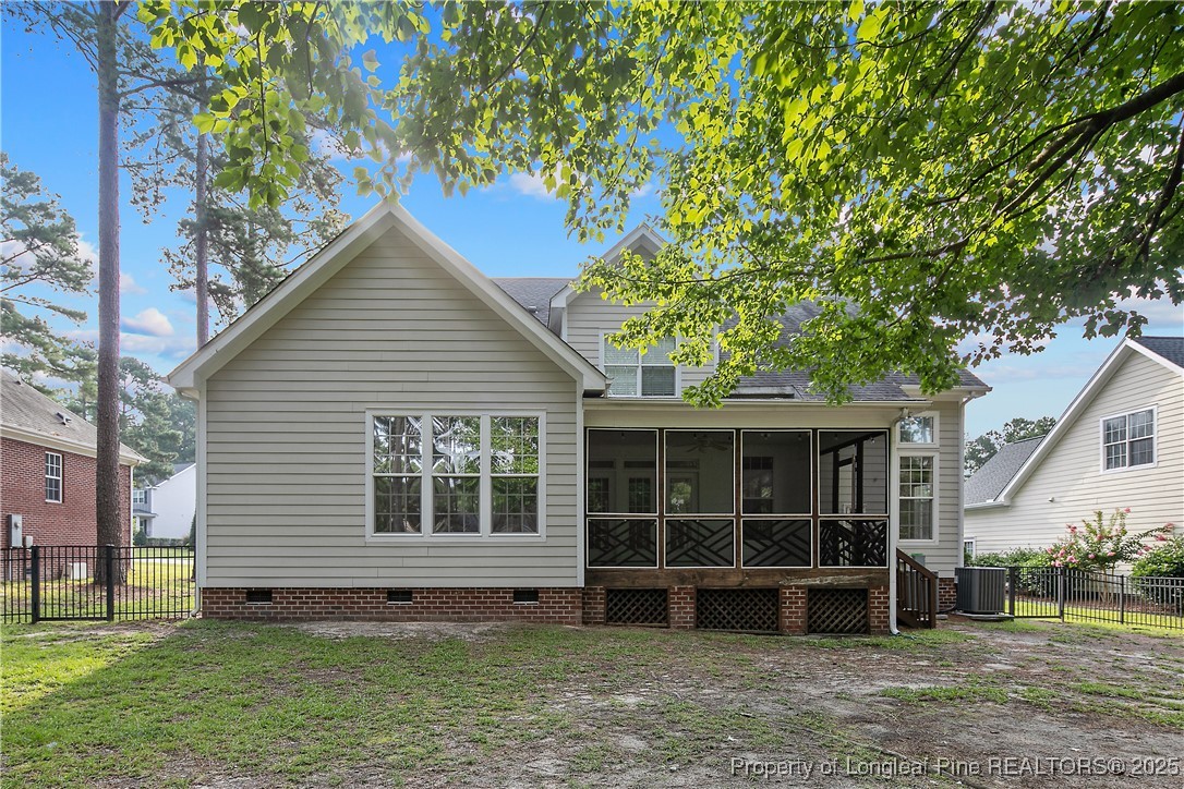 399 Falling Water Road Spring Lake, NC 28390 - Photo 2 of 50 a view of a house with a large window and a yard with plants and large trees