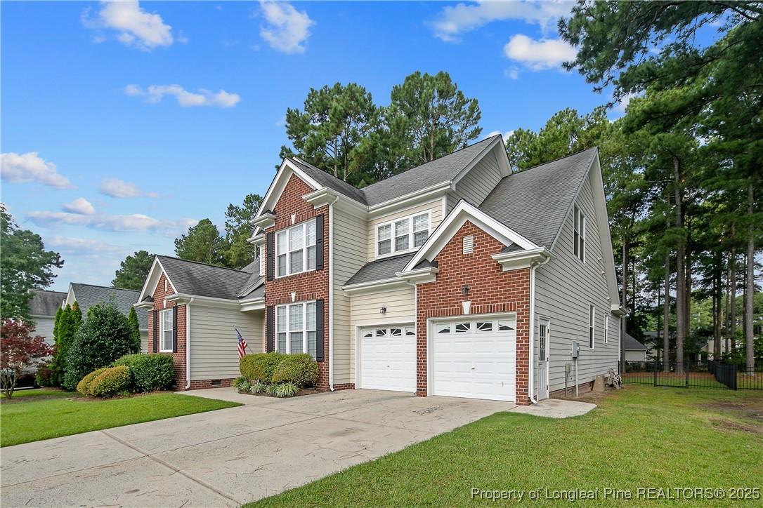399 Falling Water Road Spring Lake, NC 28390 - Photo 3 of 50 a front view of a house with a yard and garage