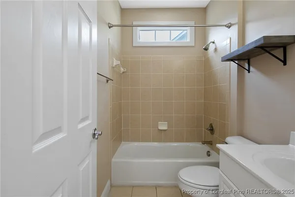 a bathroom with a toilet a sink and bathtub