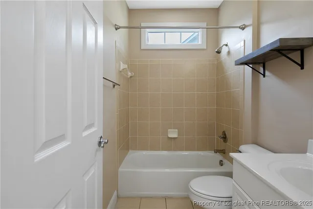a bathroom with a toilet a sink and bathtub