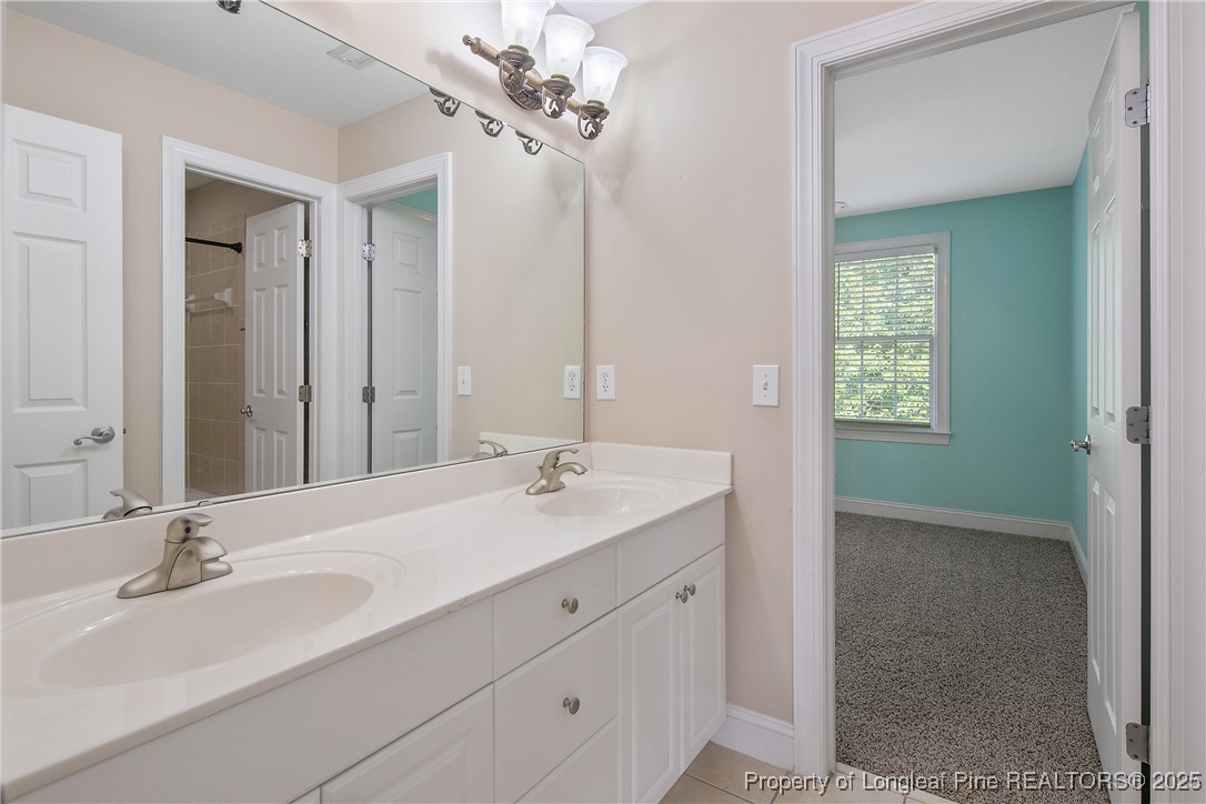 399 Falling Water Road Spring Lake, NC 28390 - Photo 39 of 50 a bathroom with a double vanity sink and a mirror