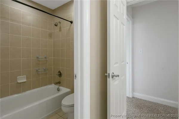 en empty room with windows and chandelier fan