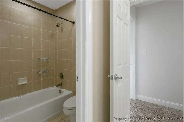 en empty room with windows and chandelier fan