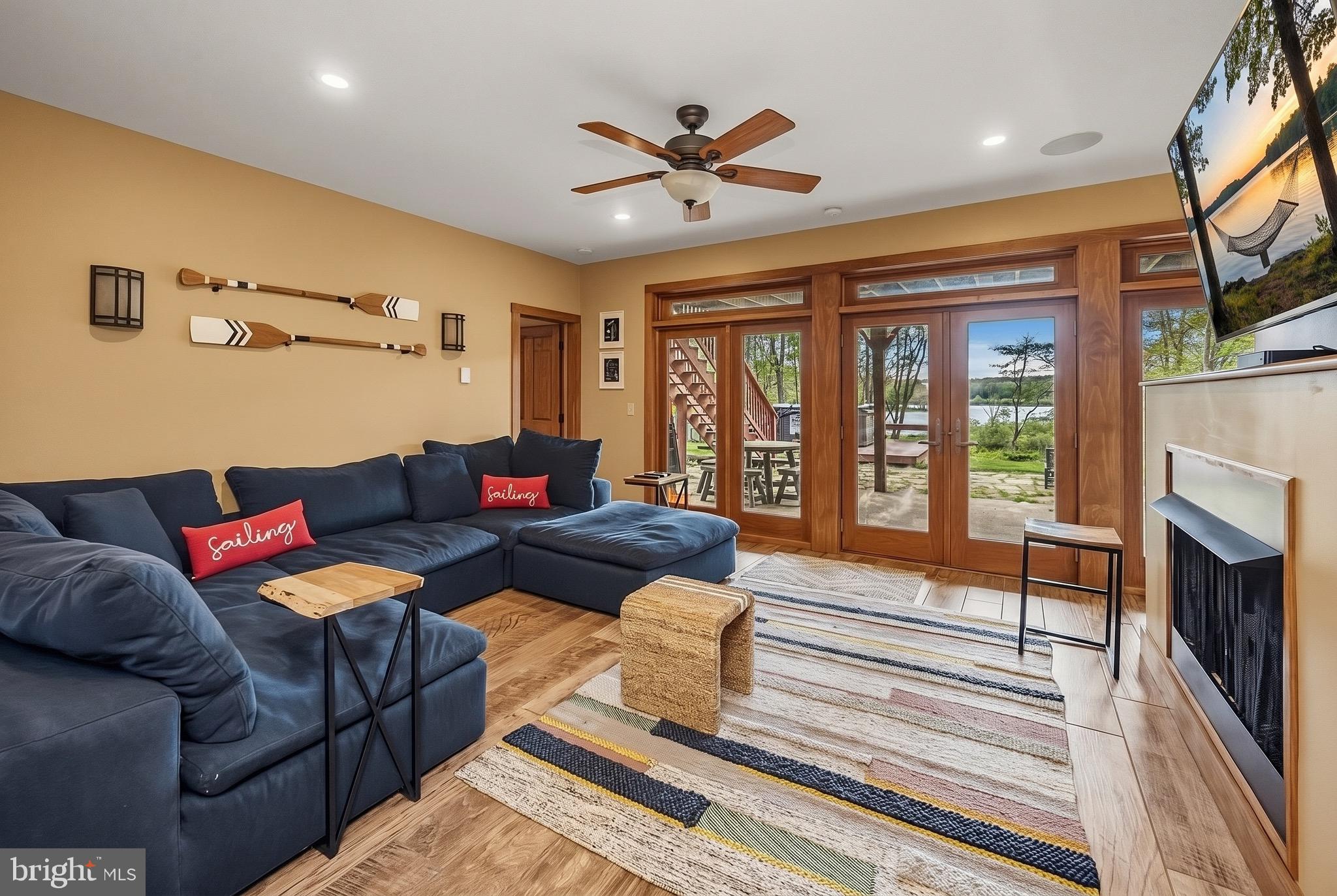 185 Ruta Lane Swanton, MD 21561 - Photo 35 of 81 a living room with furniture a fireplace and a floor to ceiling window
