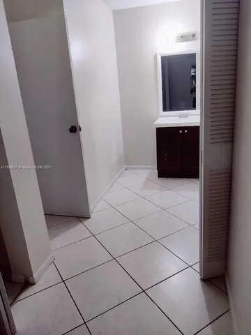 a view of a wooden fence and trees in the background