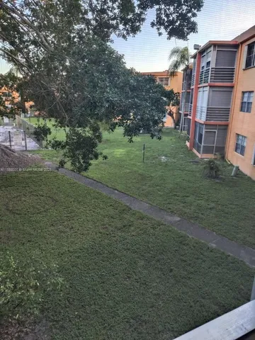 a view of a field with an trees