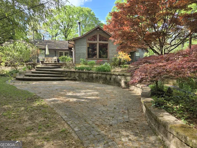 a view of a room with wooden floor and windows