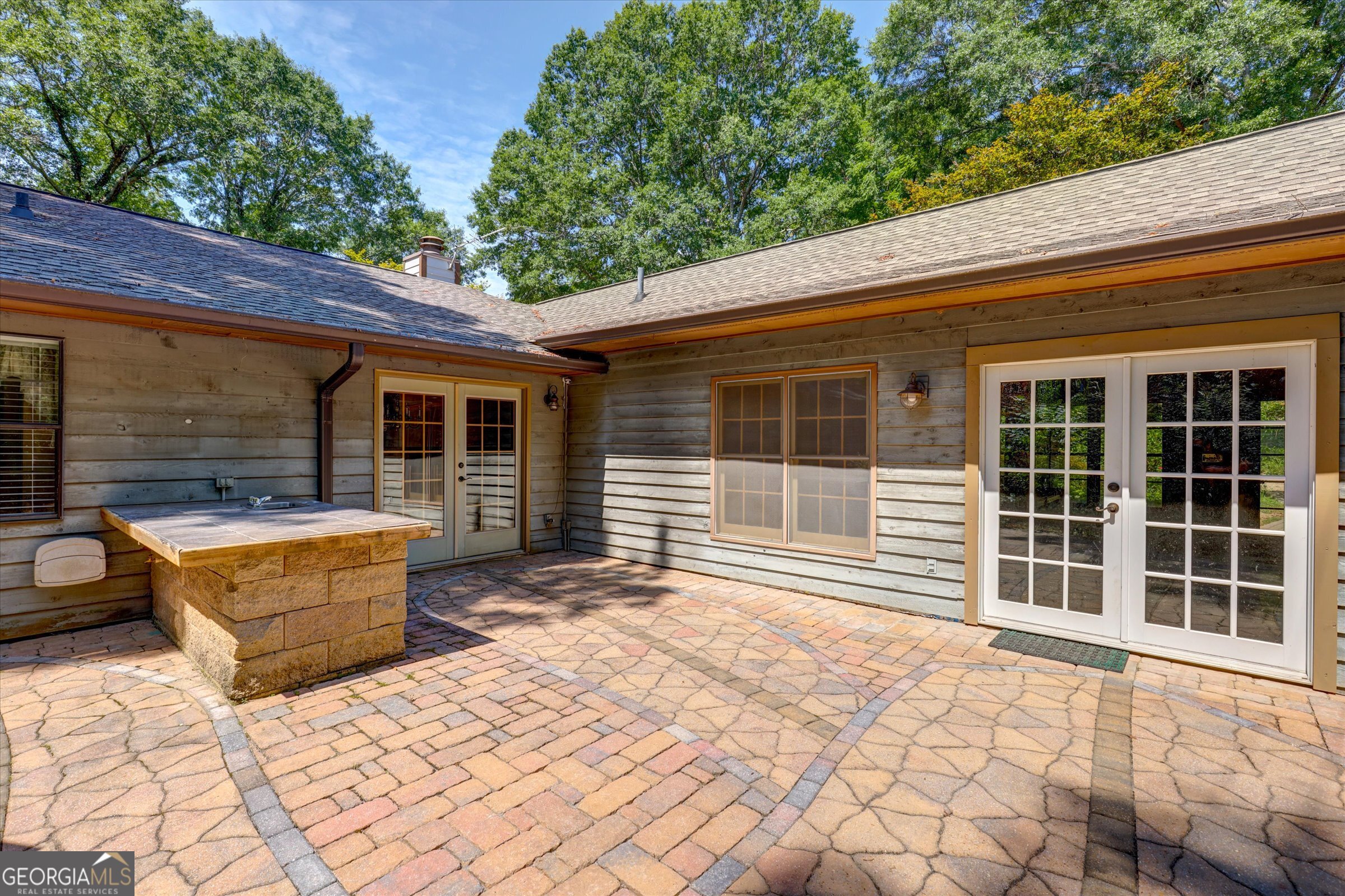 424 Hampton Road Hampton, GA 30228 - Photo 22 of 96 a backyard of a house with large window and brick wall