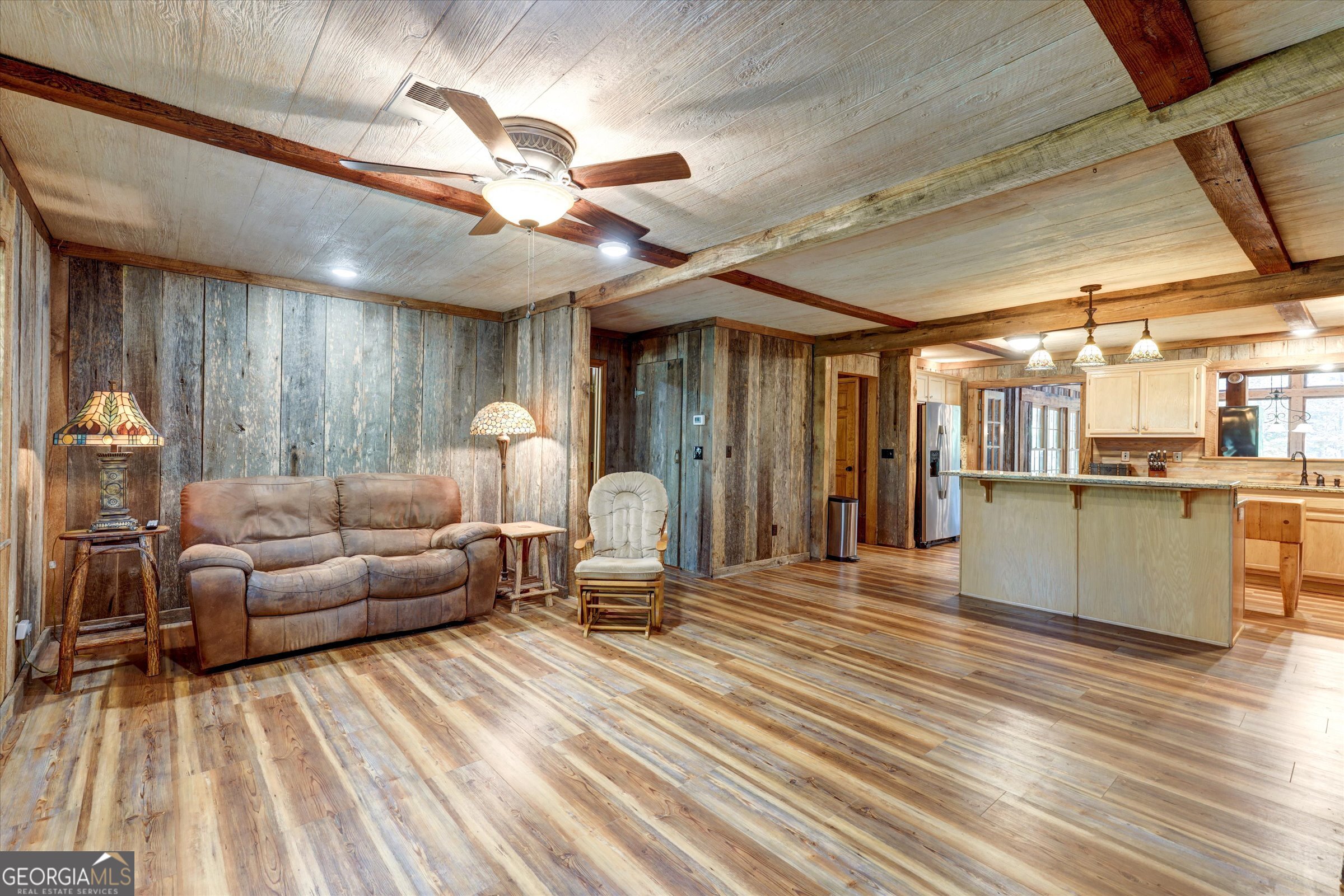 424 Hampton Road Hampton, GA 30228 - Photo 39 of 96 a living room with couches and kitchen view with wooden floor
