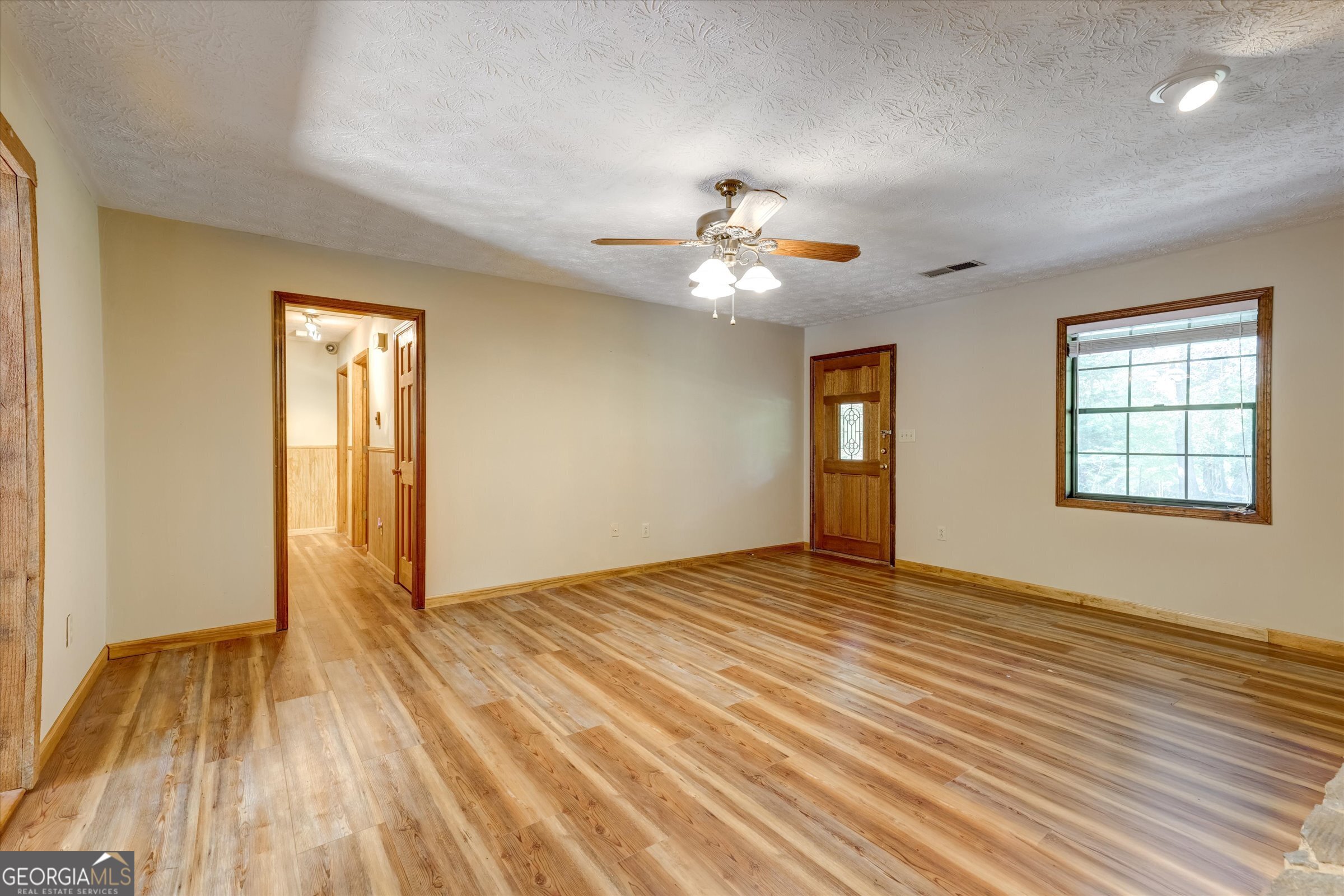 424 Hampton Road Hampton, GA 30228 - Photo 49 of 96 a view of an empty room with window and wooden floor