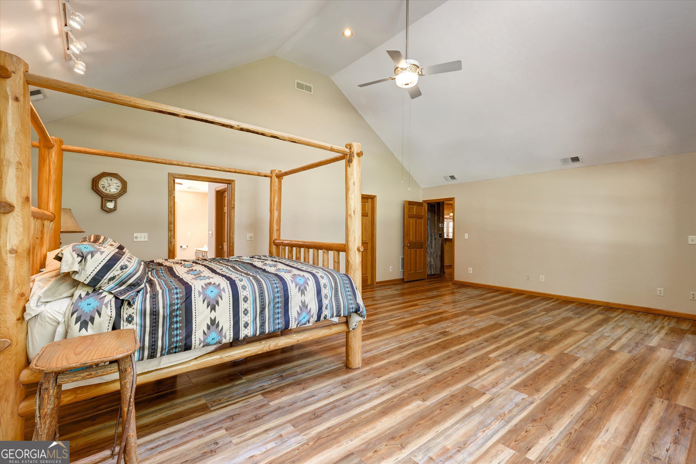 424 Hampton Road Hampton, GA 30228 - Photo 50 of 96 a bedroom with a large bed and a chandelier