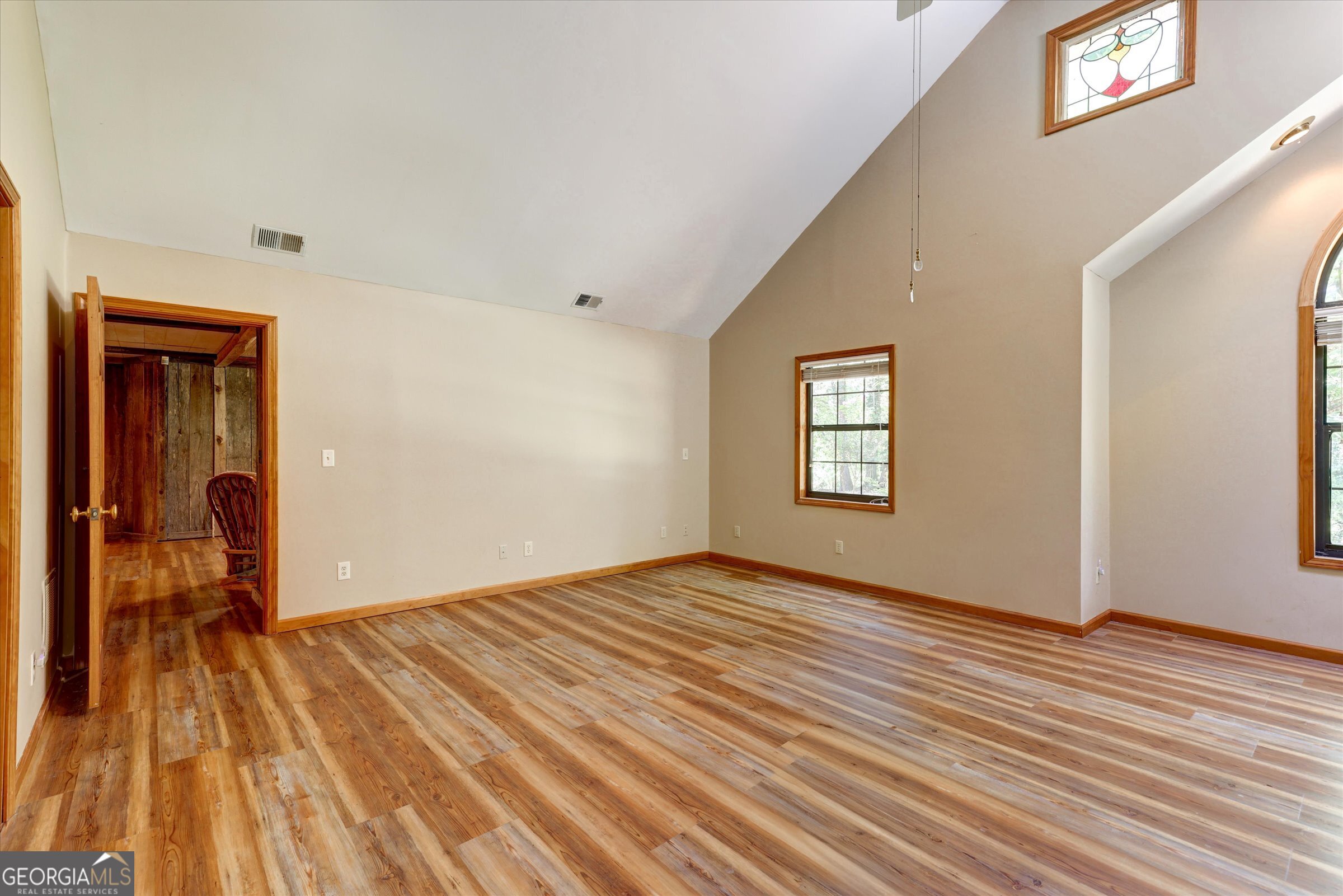 424 Hampton Road Hampton, GA 30228 - Photo 53 of 96 a view of an empty room with wooden floor and a window