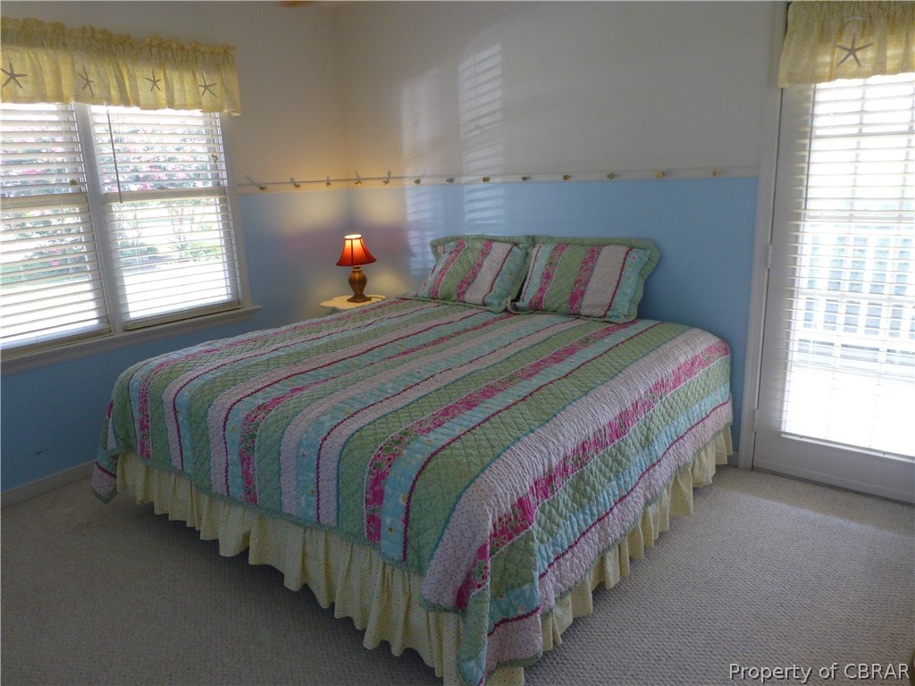 464 Jackson Creek Road Deltaville, VA 23043 - Photo 9 of 26 Spacious bedroom opens to covered porch and Jack & Jill bath