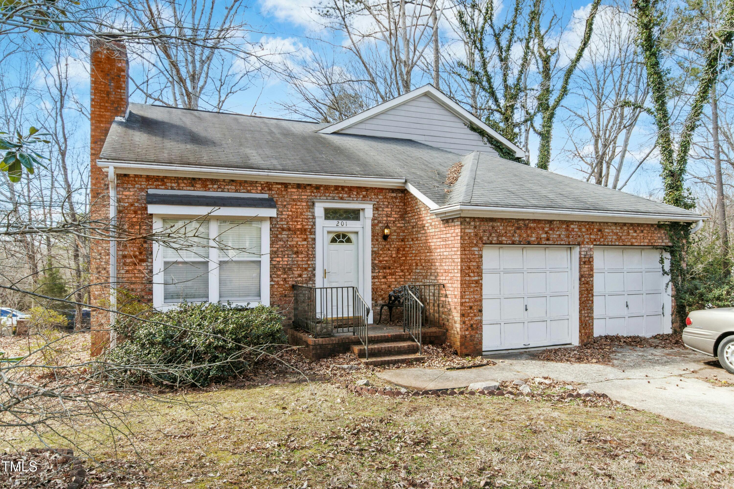 201 North Knightsbridge Road Cary, NC 27513 - Photo 5 of 7 a front view of a house with a yard and garage
