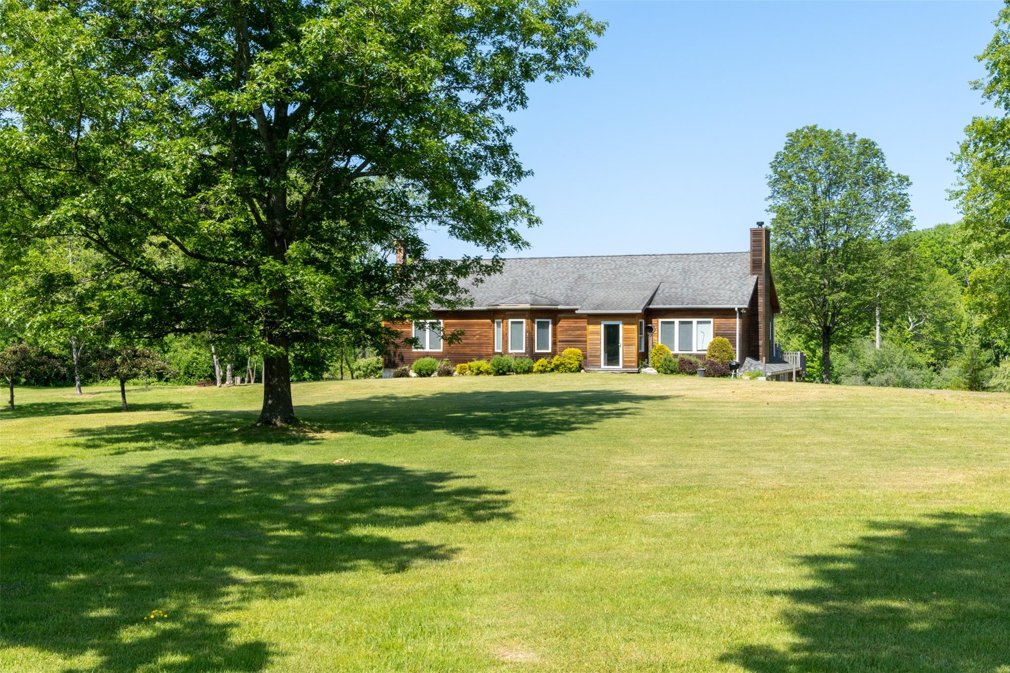 508 Woodstock Road Millbrook, NY 12545 - Photo 1 of 46 a front view of a house with a yard table and chairs