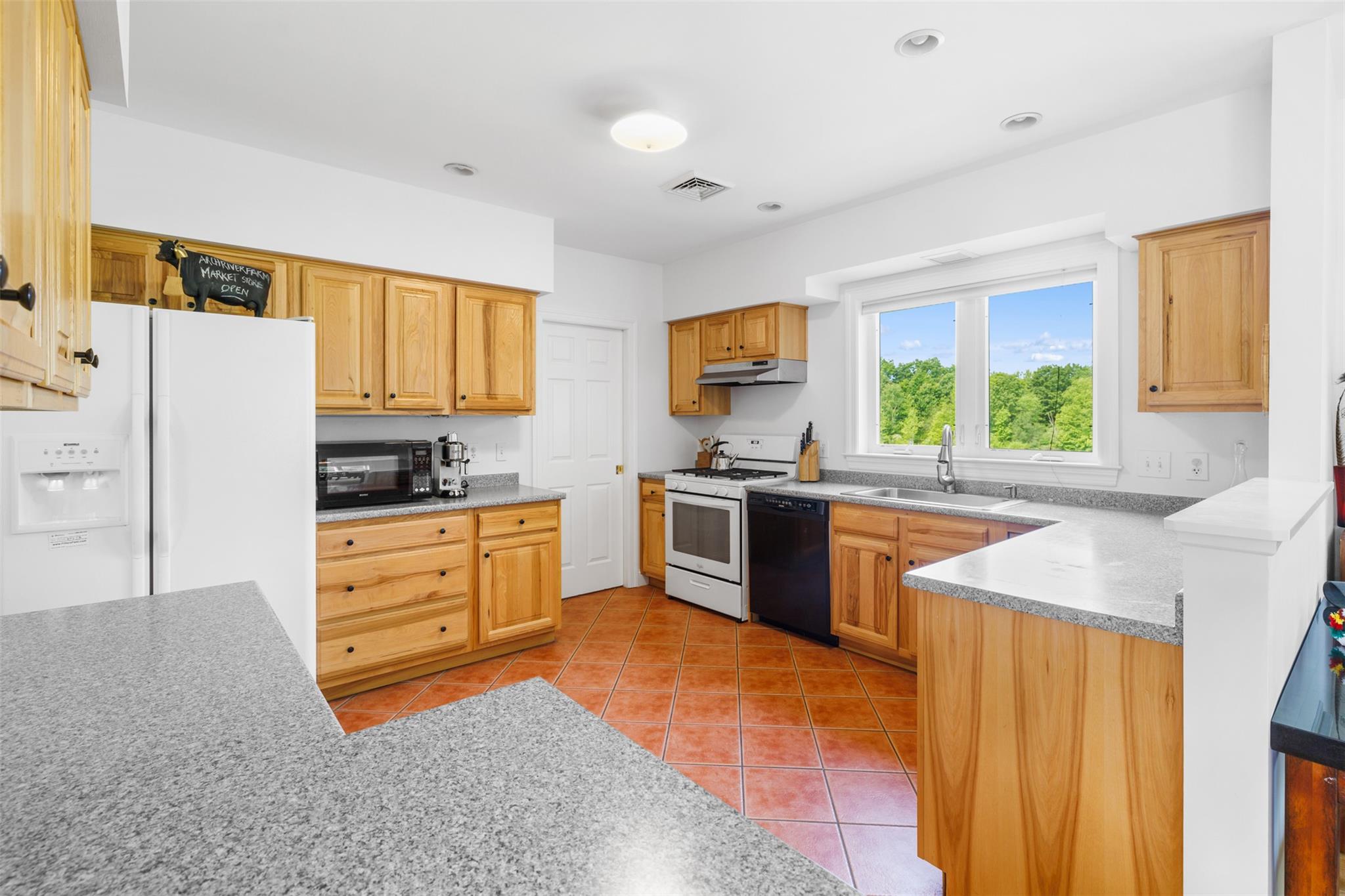 508 Woodstock Road Millbrook, NY 12545 - Photo 14 of 46 a kitchen with stainless steel appliances kitchen island granite countertop a stove a sink and a refrigerator