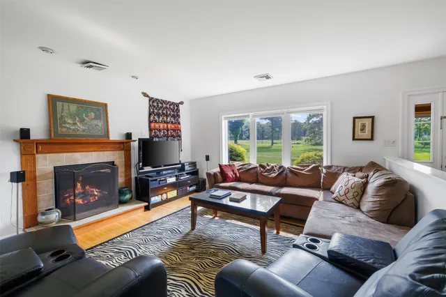 a living room with furniture and a fireplace