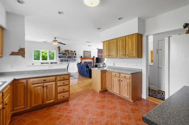 a kitchen with stainless steel appliances granite countertop a stove a sink dishwasher and a refrigerator