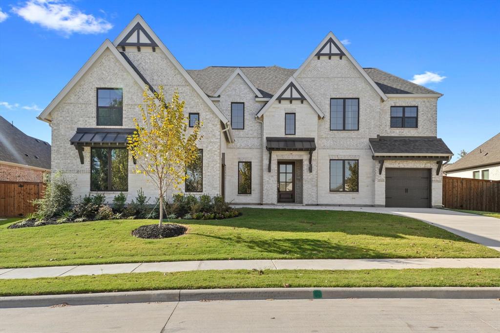 a view of a white house with a yard and plants
