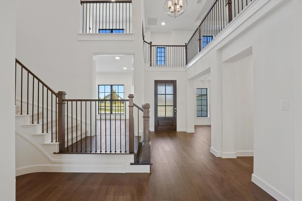 4626 Rillstone Road Midlothian, TX 76065 - Photo 2 of 40 Entrance foyer with dark wood-style flooring, a towering ceiling, recessed lighting, stairway, and a chandelier