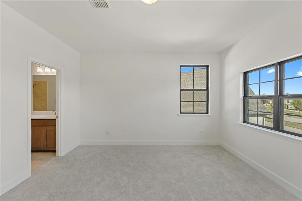 4626 Rillstone Road Midlothian, TX 76065 - Photo 27 of 40 Unfurnished bedroom featuring light colored carpet and connected bathroom