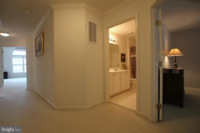 a view of a kitchen from a hallway