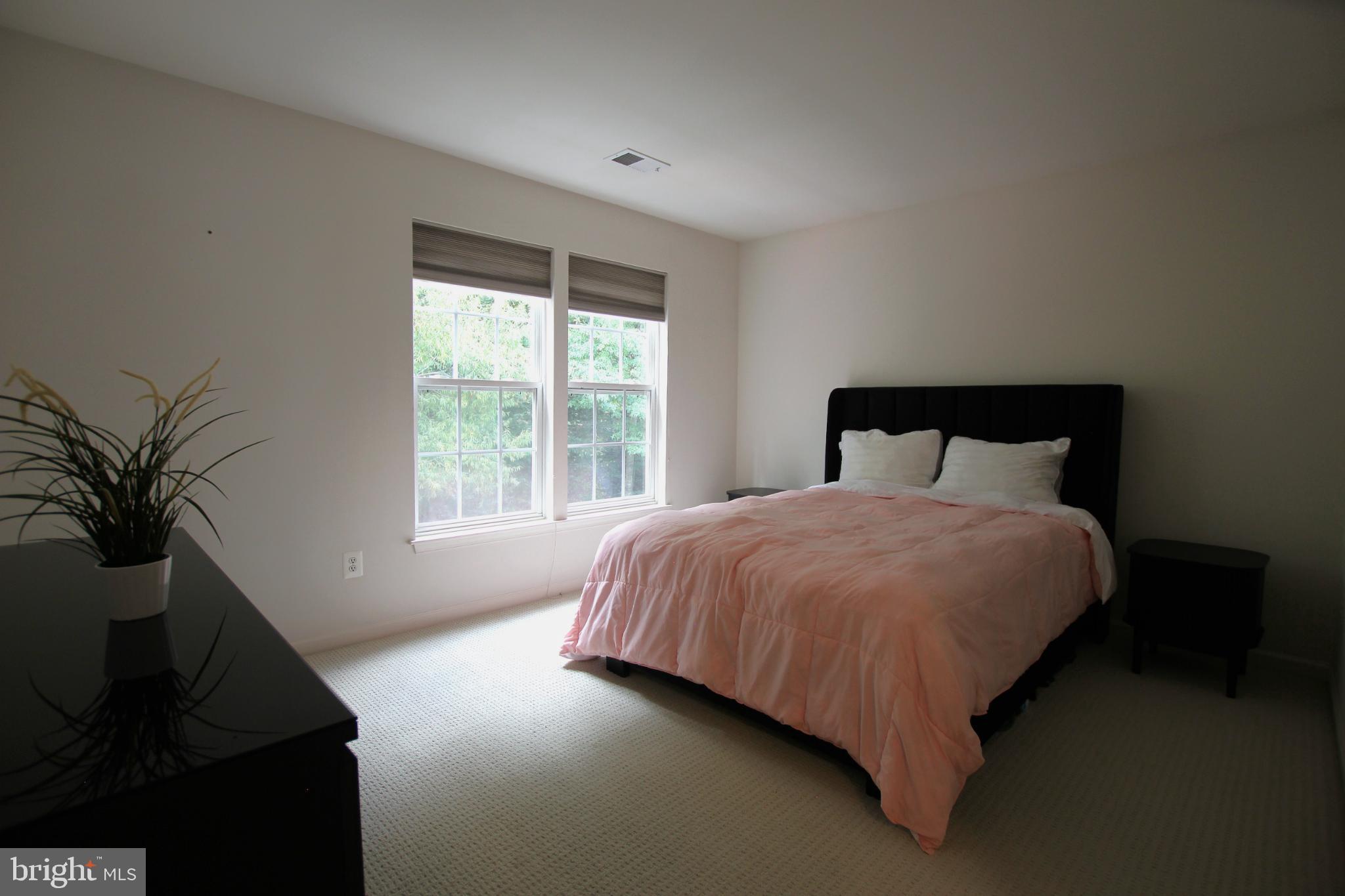 8532 Barrow Furnace Lane Lorton, VA 22079 - Photo 25 of 33 a bed sitting in a bedroom next to a window