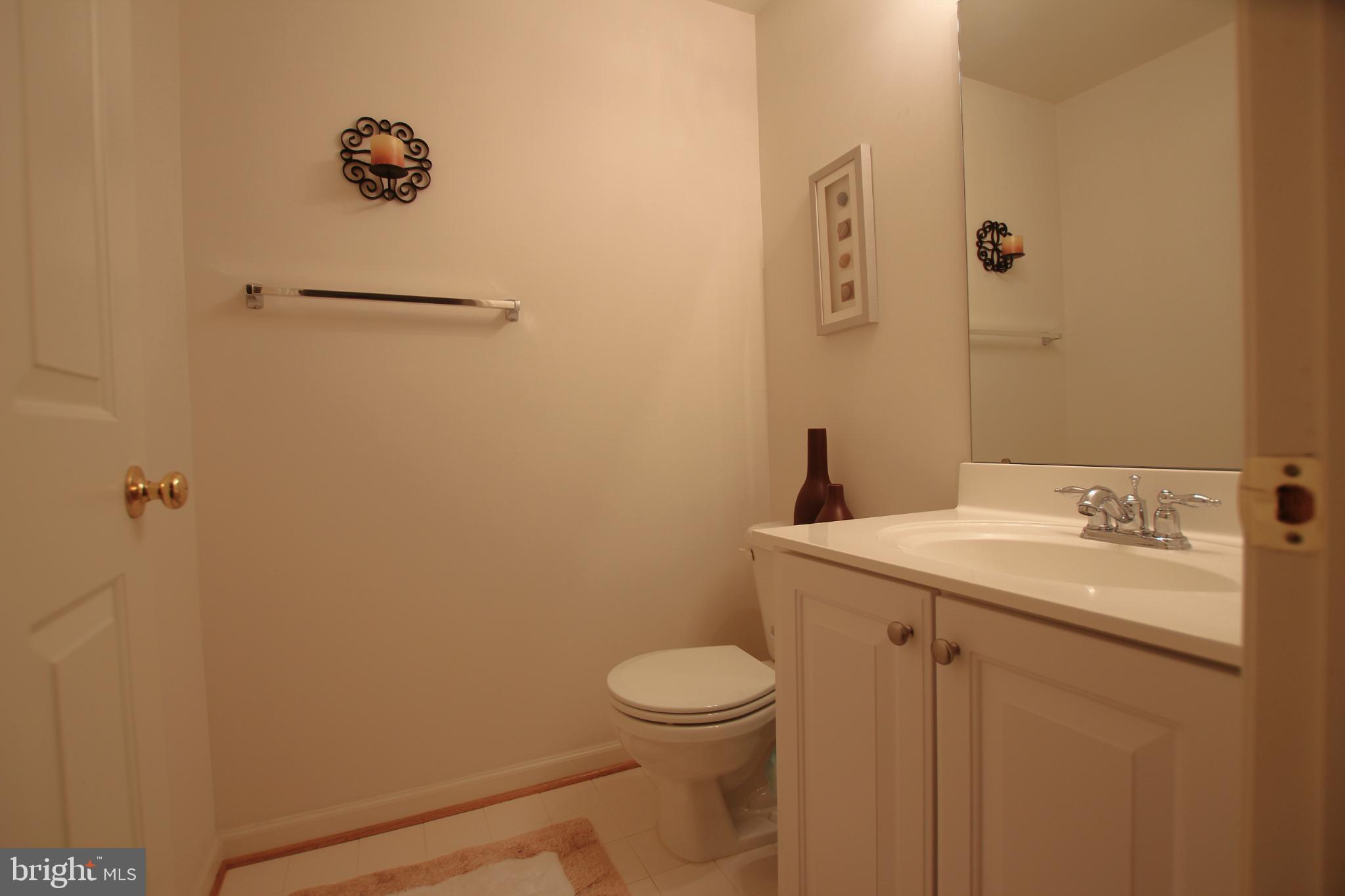 8532 Barrow Furnace Lane Lorton, VA 22079 - Photo 29 of 33 a bathroom with a toilet a sink and mirror