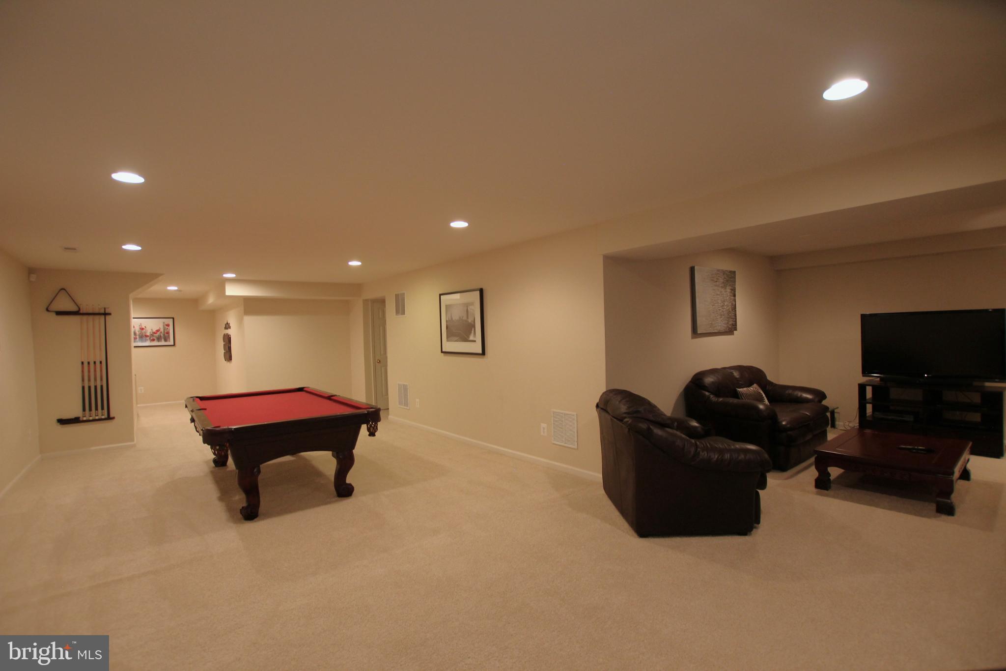 8532 Barrow Furnace Lane Lorton, VA 22079 - Photo 30 of 33 a living room with furniture and a flat screen tv