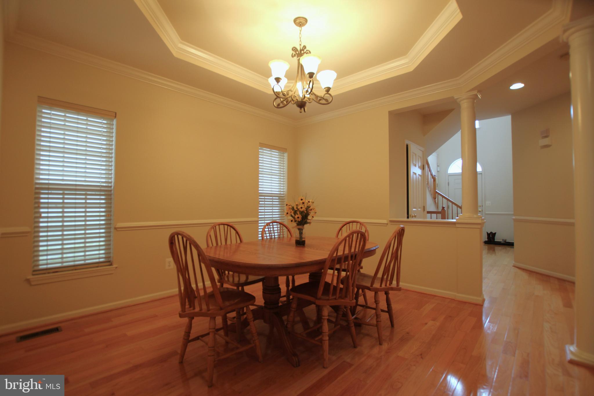 8532 Barrow Furnace Lane Lorton, VA 22079 - Photo 5 of 33 a view of a a dining room with furniture a chandelier and wooden floor